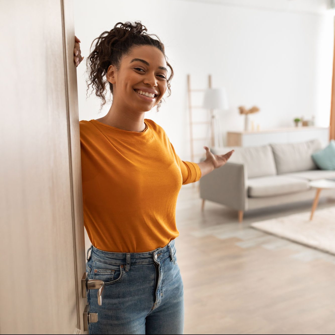 A real estate agent welcoming people into a home